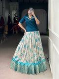 Teal colored Dola Chex lehenga choli featuring floral prints and decorative Zari weaving border