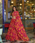 Model wearing a vibrant fuchsia pink and yellow floral print chiffon lehenga choli set with dupatta