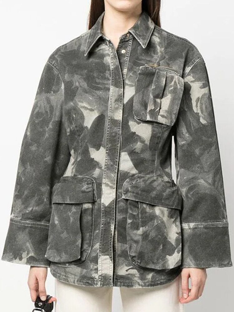 Women's grey camouflage utility jacket with button-front closure and multiple flap pockets, styled for streetwear.