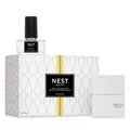 A modern, geometric white and gold wall diffuser set with grapefruit fragrance.
