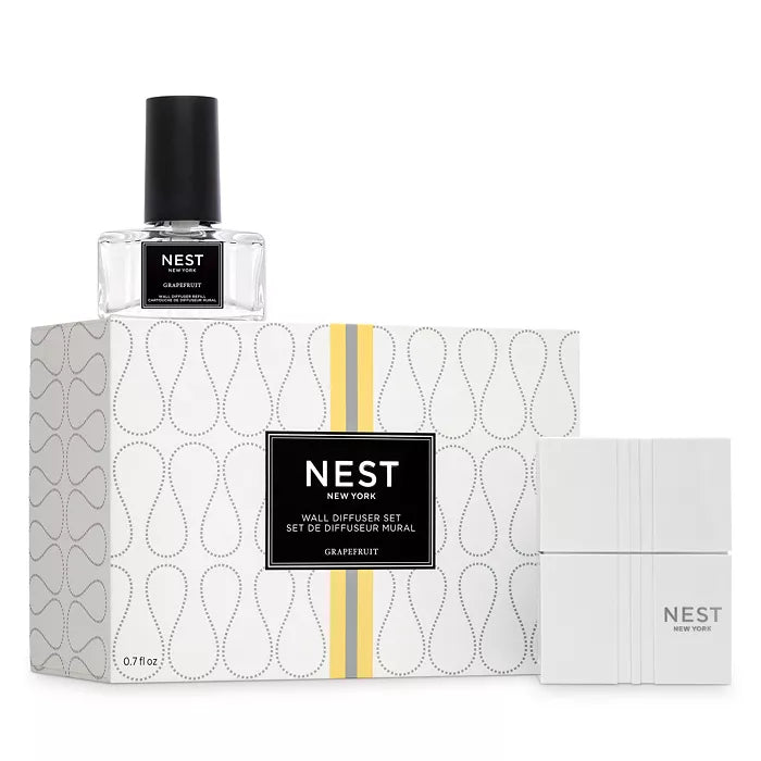 A modern, geometric white and gold wall diffuser set with grapefruit fragrance.