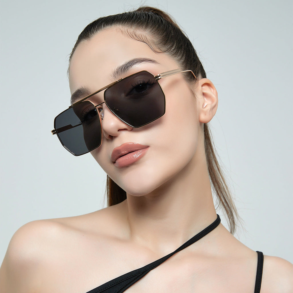Modern double beam sunglasses with a large frame silhouette and copper finish.
