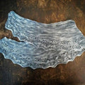 A finished hand-knit lace weight shawl made from the End of Summer Shawl Kit