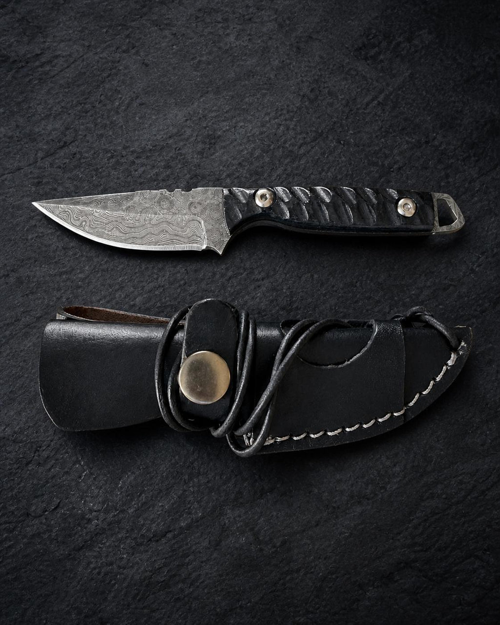 Titan Shadow Scale Damascus hunting knife with black Micarta handle and leather sheath