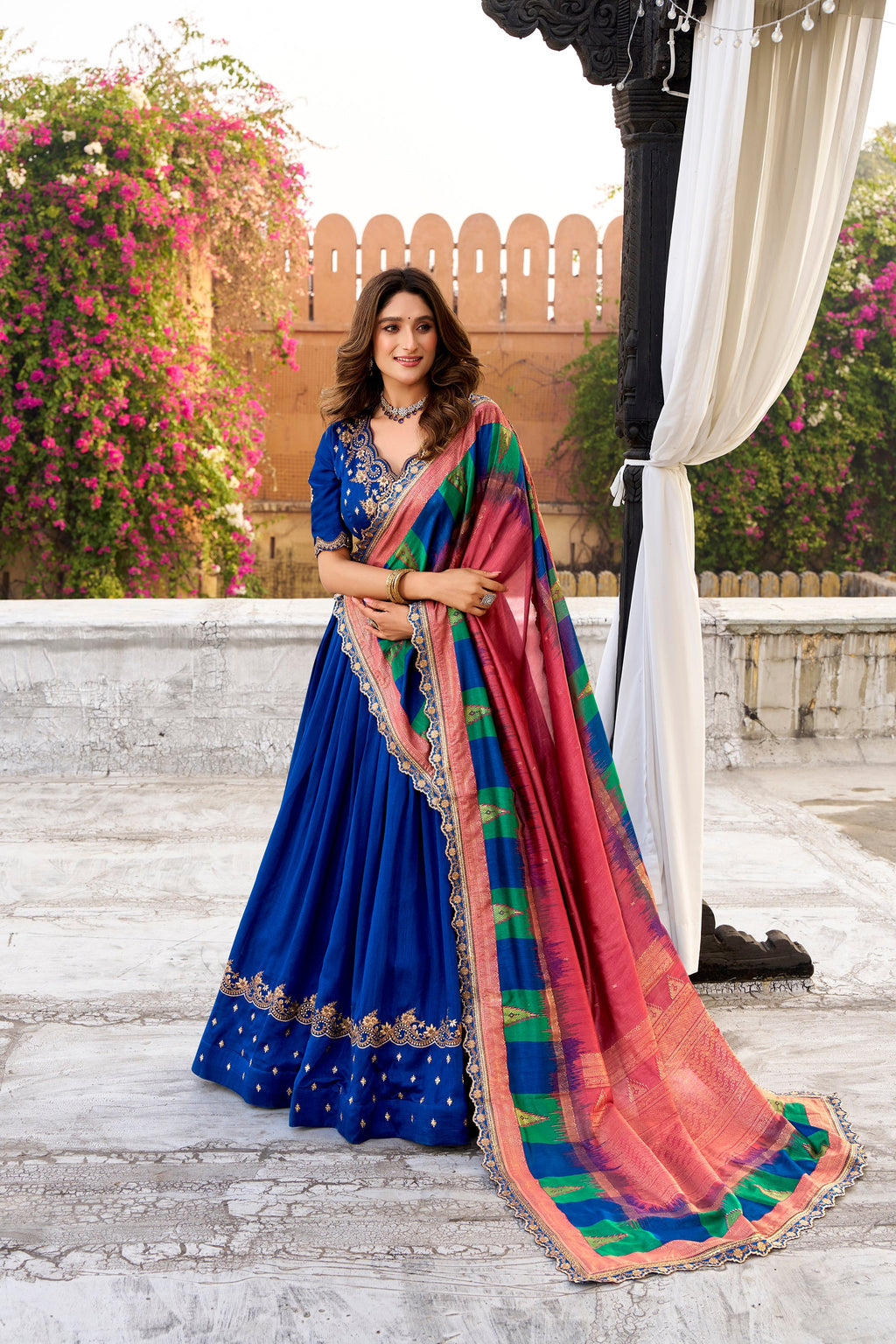 Royal blue Vichitra silk lehenga choli with ornate thread embroidery and sequins.