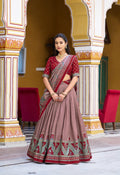 Maroon Tasar silk lehenga choli with ethnic prints, sparkle accents, and lace border
