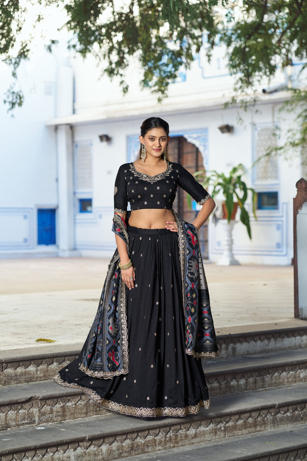 Black Vichitra silk lehenga choli set with intricate sequins and thread embroidery.