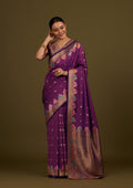 A beautiful dark violet Banarasi silk blend saree featuring intricate gold zari woven patterns
