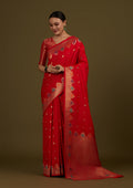 Red Banarasi silk blend saree with ornate zari woven patterns.