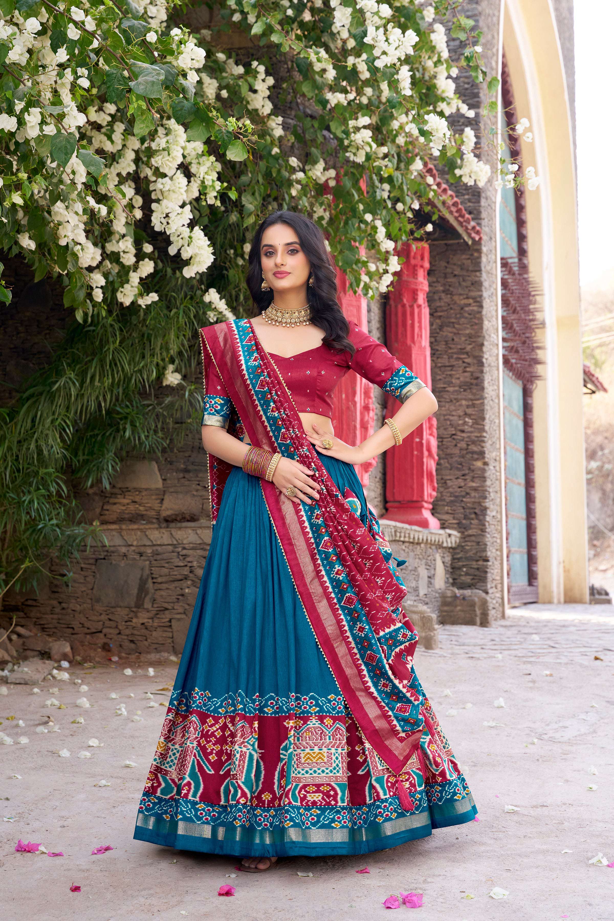 Teal Tussar silk lehenga with Patola print and foil work details