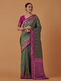 Dark olive Banarasi silk blend saree featuring a rich zari woven brocade pattern.