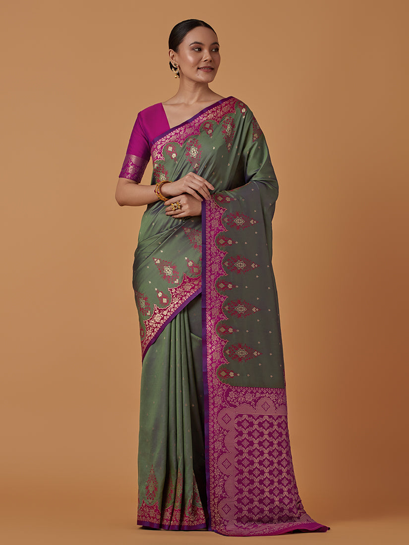 Dark olive Banarasi silk blend saree featuring a rich zari woven brocade pattern.