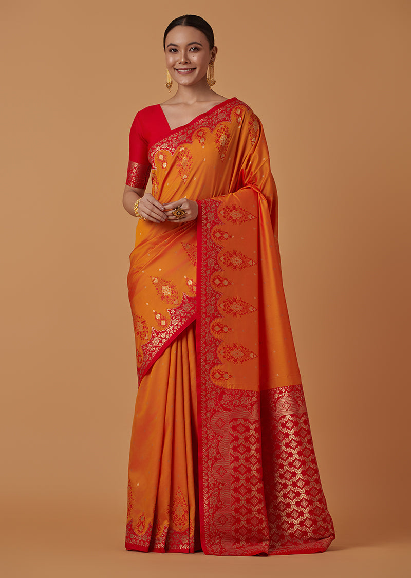 Amber Banarasi silk blend saree with intricate gold zari woven brocade and deep red border detail