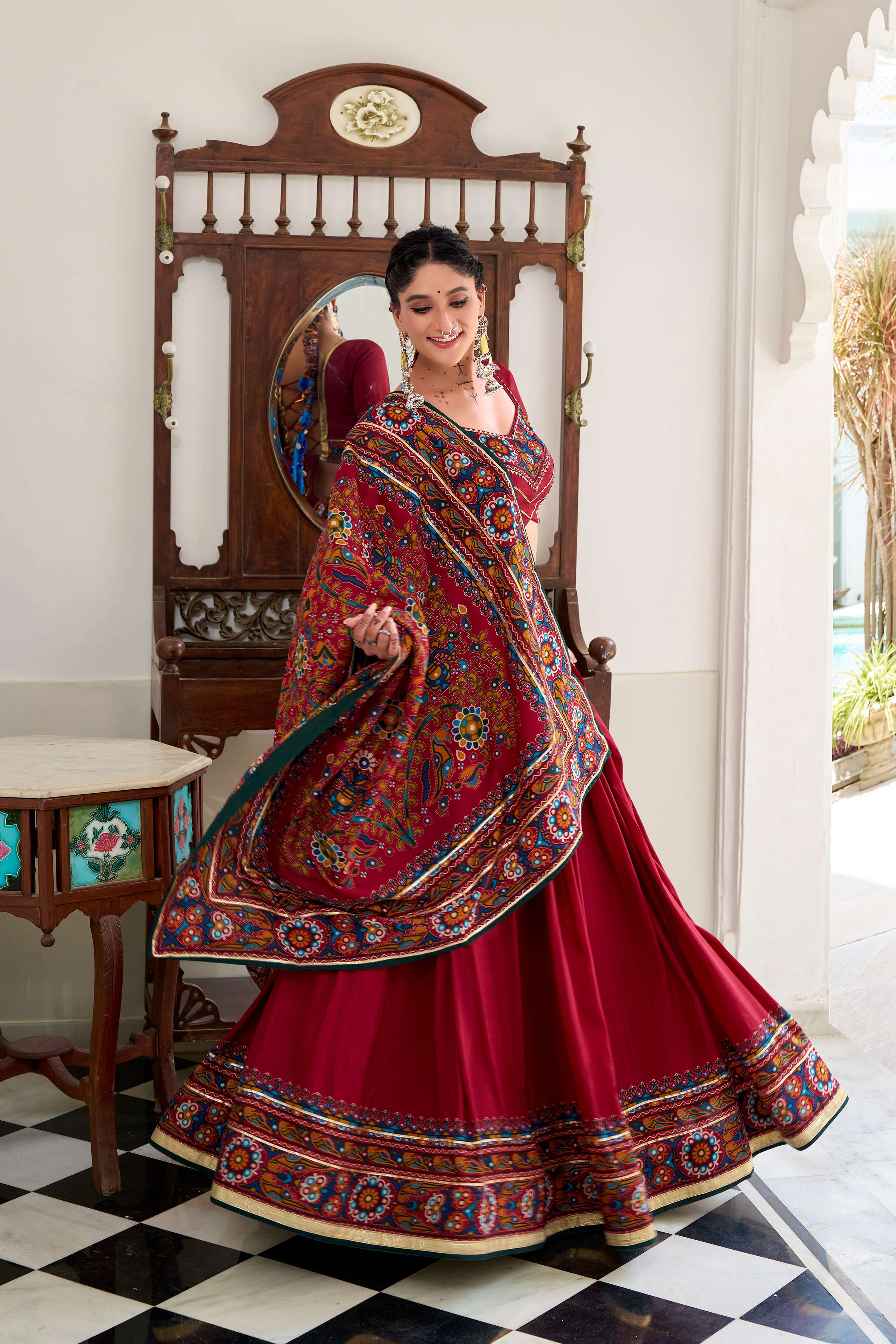 Red Tasar silk lehenga choli with traditional Gamthi print and Gotta Patti lace detailing