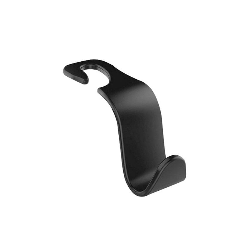 Universal black car seat headrest hook holding a diaper bag in a car interior