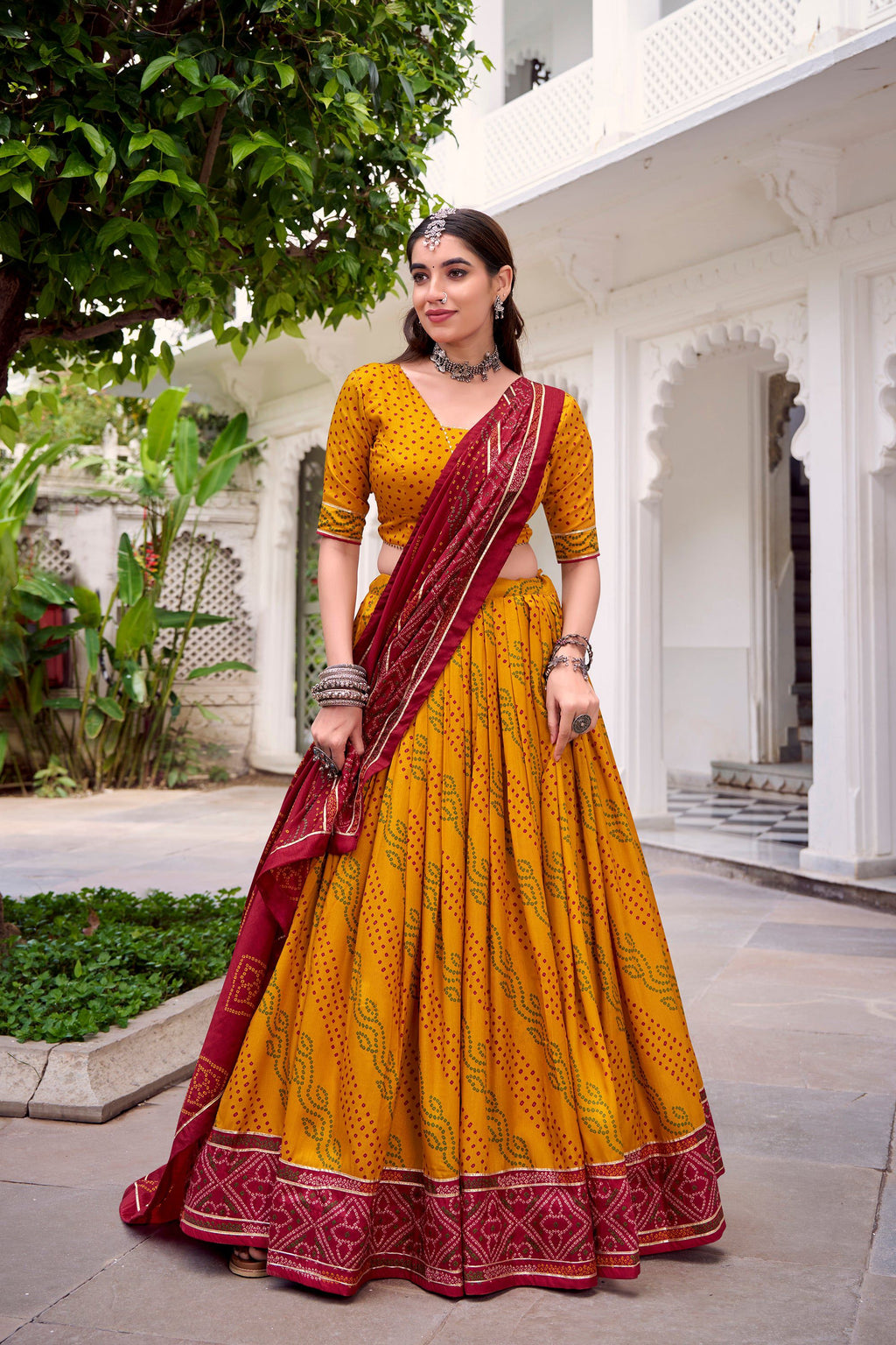 Yellow Tasar Silk Bandhej Lehenga Choli with Gotta Patti lace work.