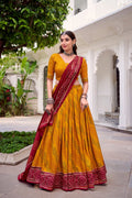 Yellow Tasar Silk Bandhej Lehenga Choli with Gotta Patti lace work.