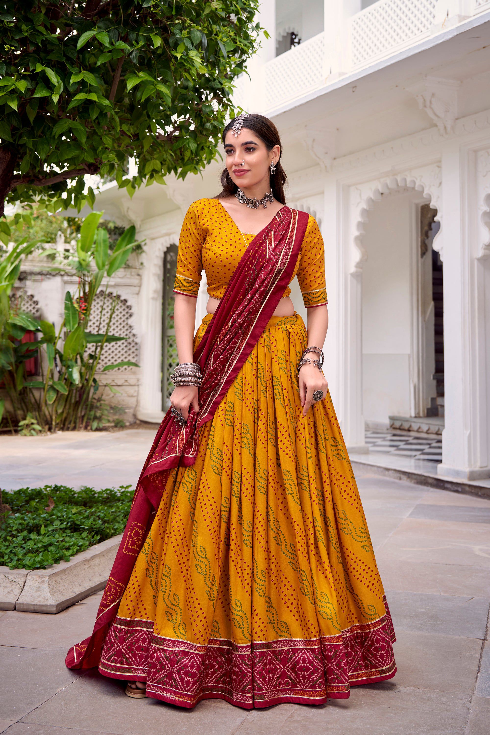 Yellow Tasar Silk Bandhej Lehenga Choli with Gotta Patti lace work.