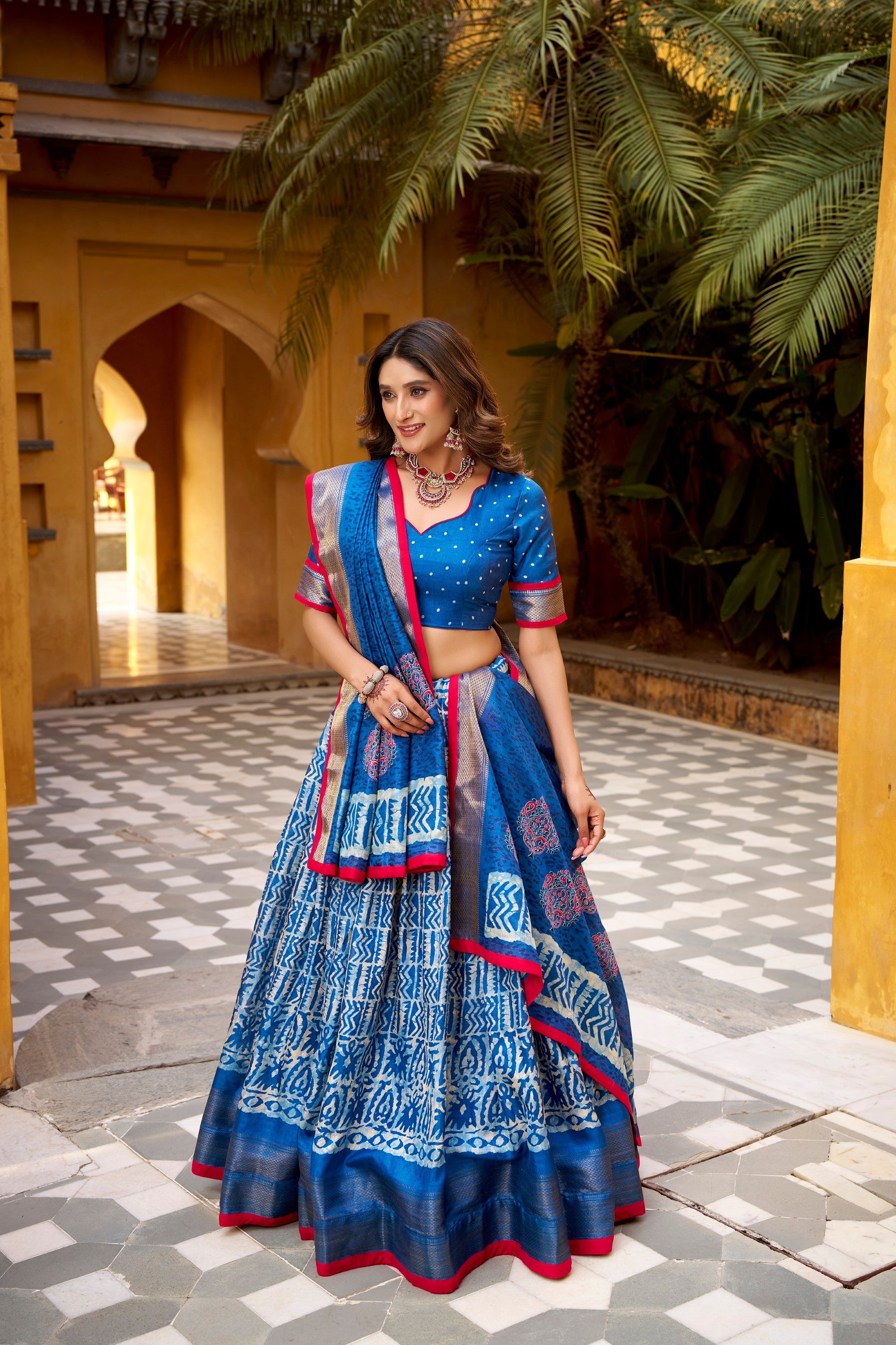 Blue Dola Silk lehenga choli with Batik print and gold Zari weaving detail.