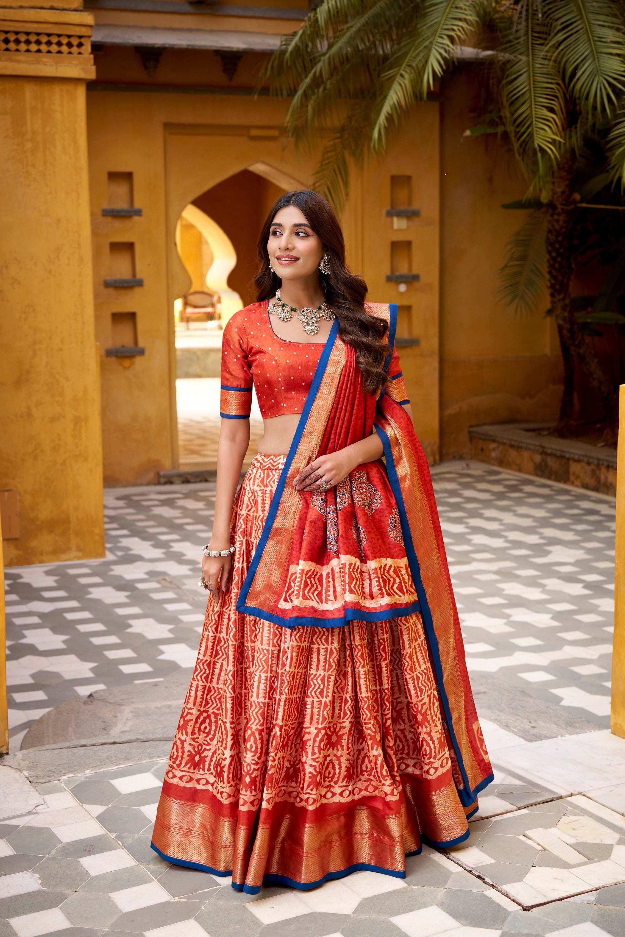 Rust Dola Silk Batik Print Lehenga Choli with Zari Weaving