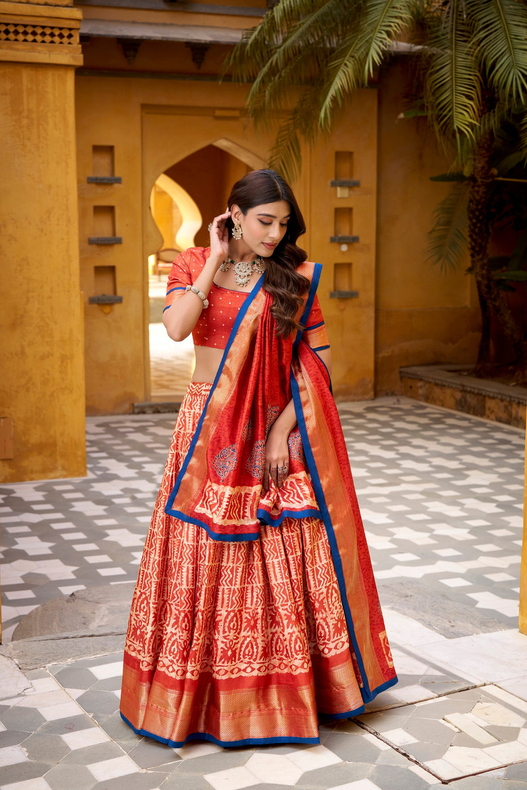Rust Dola Silk Batik Print Lehenga Choli with Zari Weaving