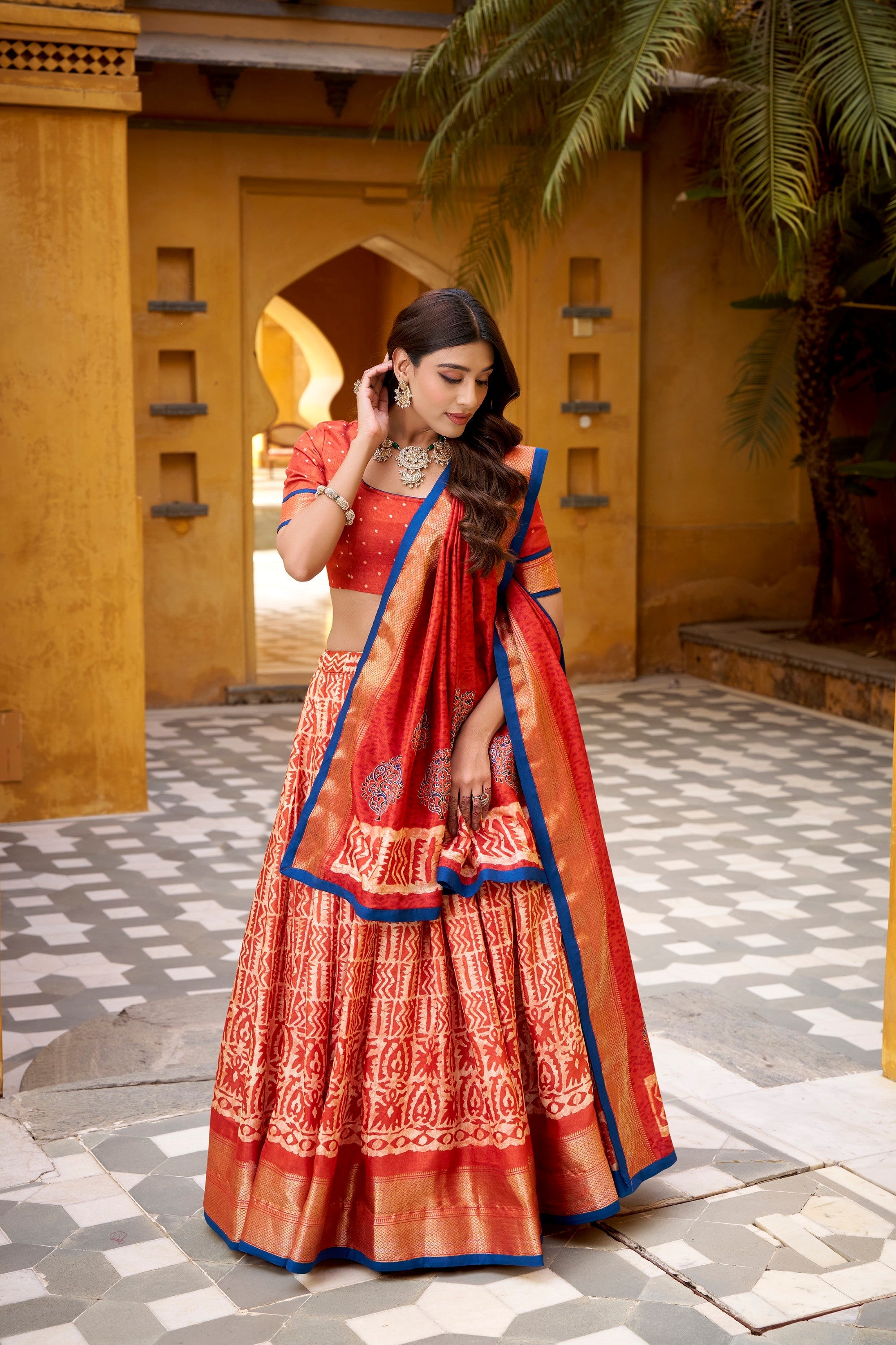 Rust Dola Silk Batik Print Lehenga Choli with Zari Weaving