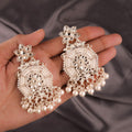 Gold-plated brass stud earrings with white Kundan stones and pearl accents