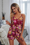 Woman wearing a sleeveless floral matching set in wine color