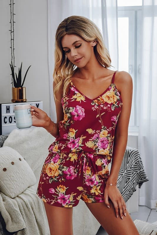 Woman wearing a sleeveless floral matching set in wine color