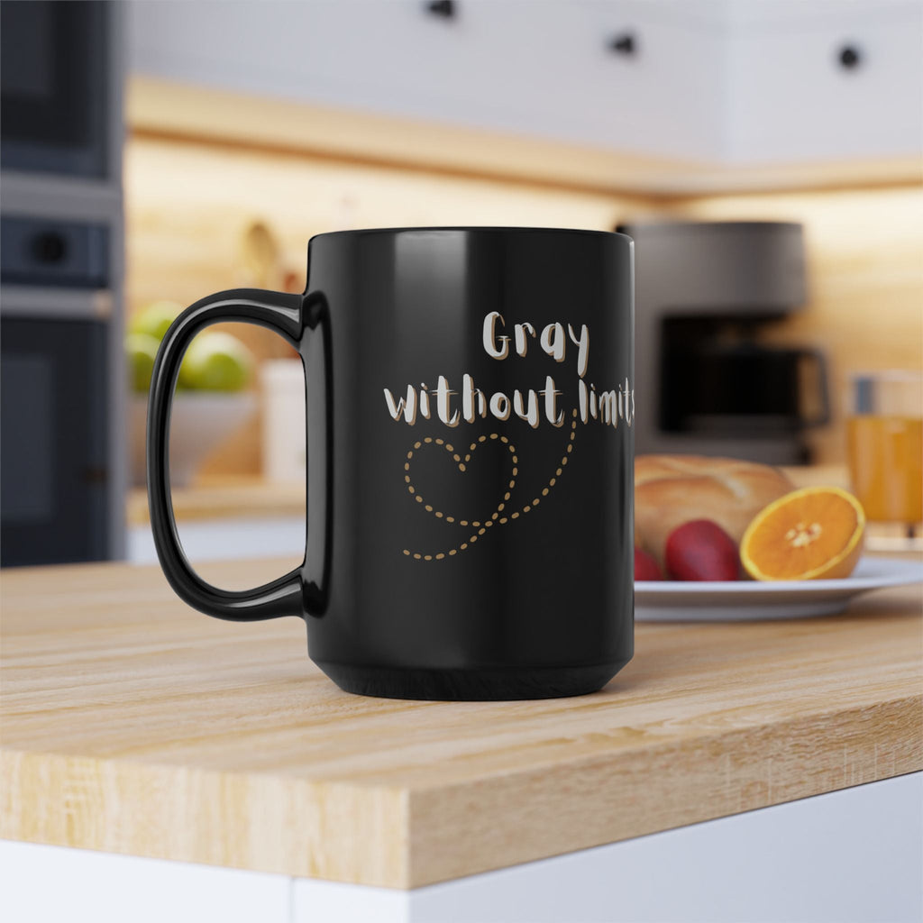 A sleek 15oz black glossy coffee mug with Gray Without Limits text in a modern kitchen setting.
