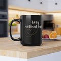 A sleek 15oz black glossy coffee mug with Gray Without Limits text in a modern kitchen setting.