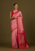 Light pink Banarasi silk blend saree featuring paisley patterns and a rich gold Zari pallu.