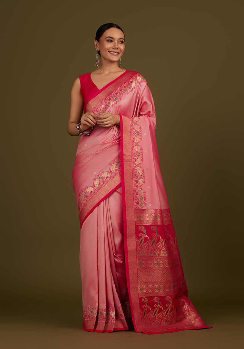 Light pink Banarasi silk blend saree featuring paisley patterns and a rich gold Zari pallu.