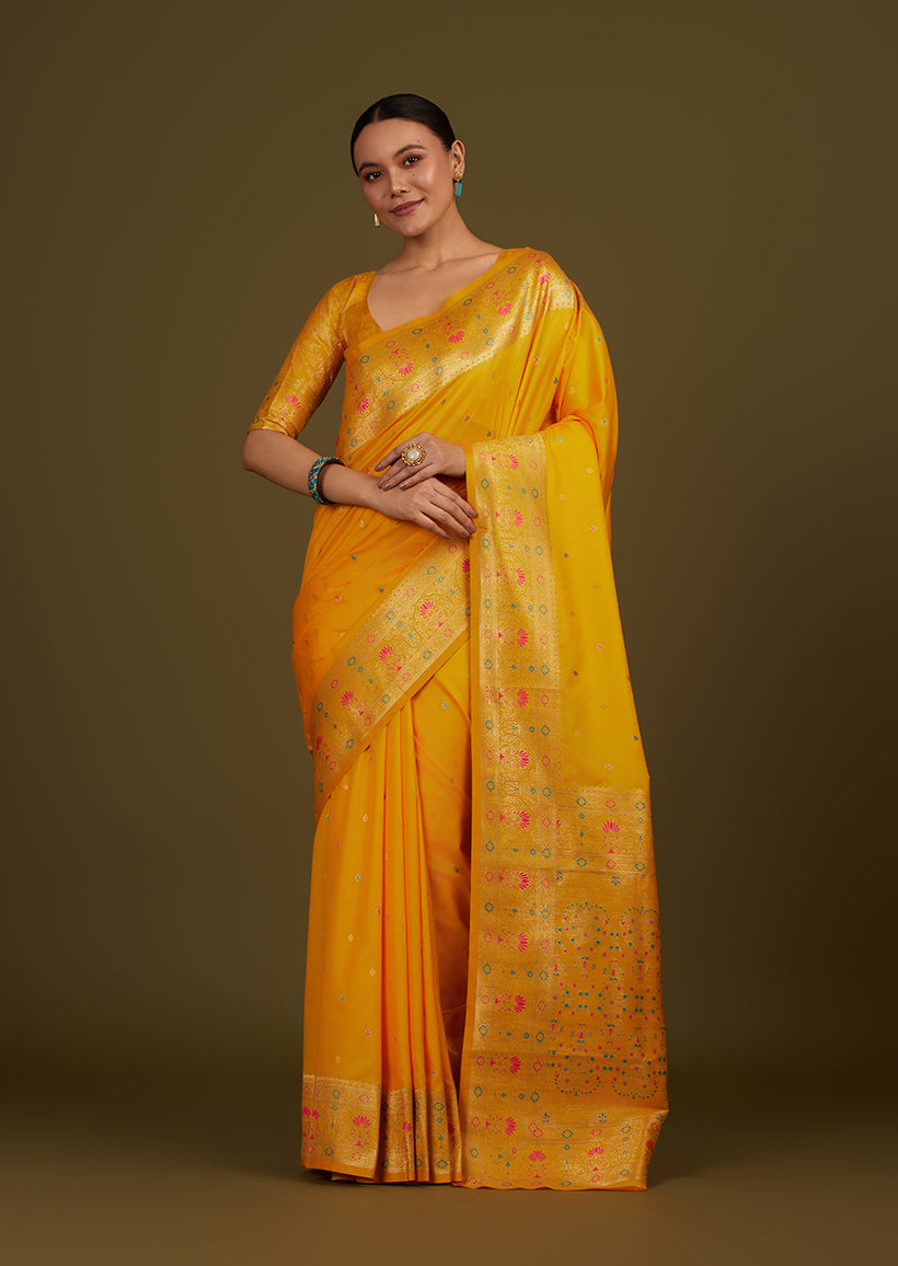 Bright yellow Banarasi silk blend saree with intricate golden zari woven brocade motifs
