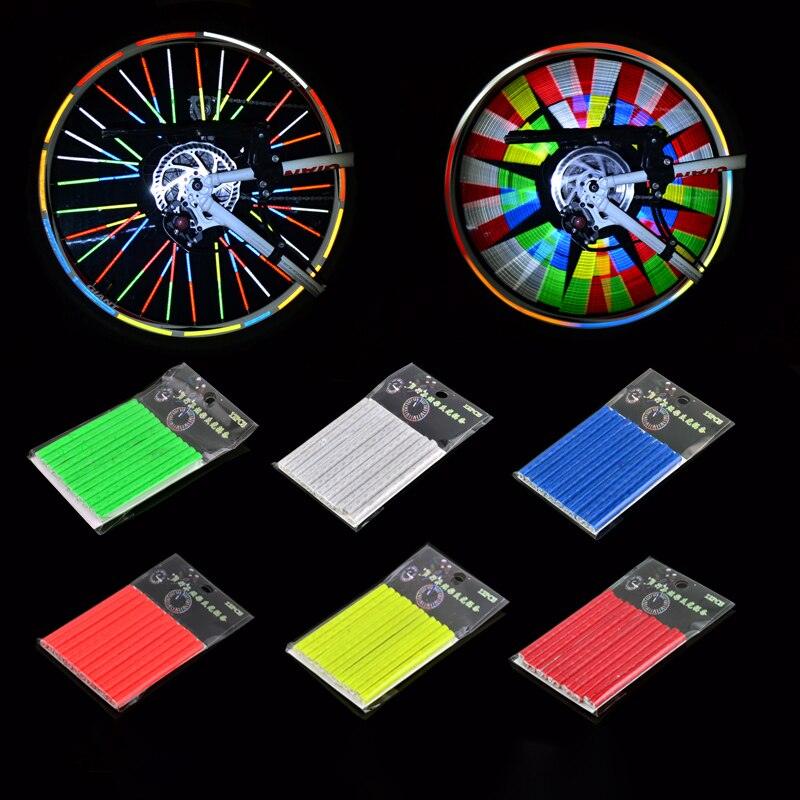 12-piece set of reflective bicycle spoke clips attached to a bike wheel for night safety.