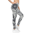 Woman wearing high-rise floral leggings with a monochromatic black and white print for a sporty athletic look