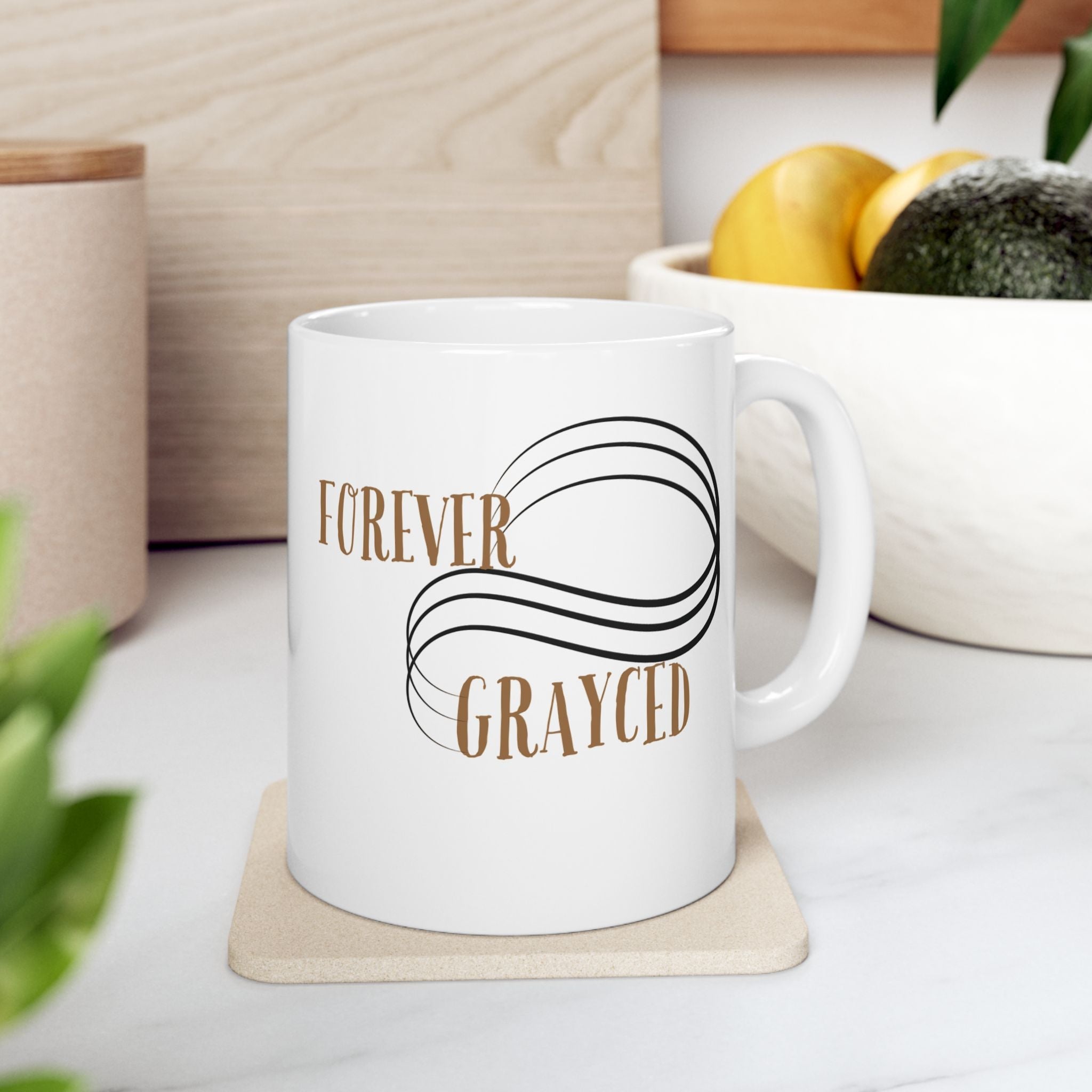 Modern white ceramic mug with minimalist black graphic design on a clean office desk background.