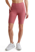 Women's high-rise compression cycling shorts with side phone pockets in muted athletic tone