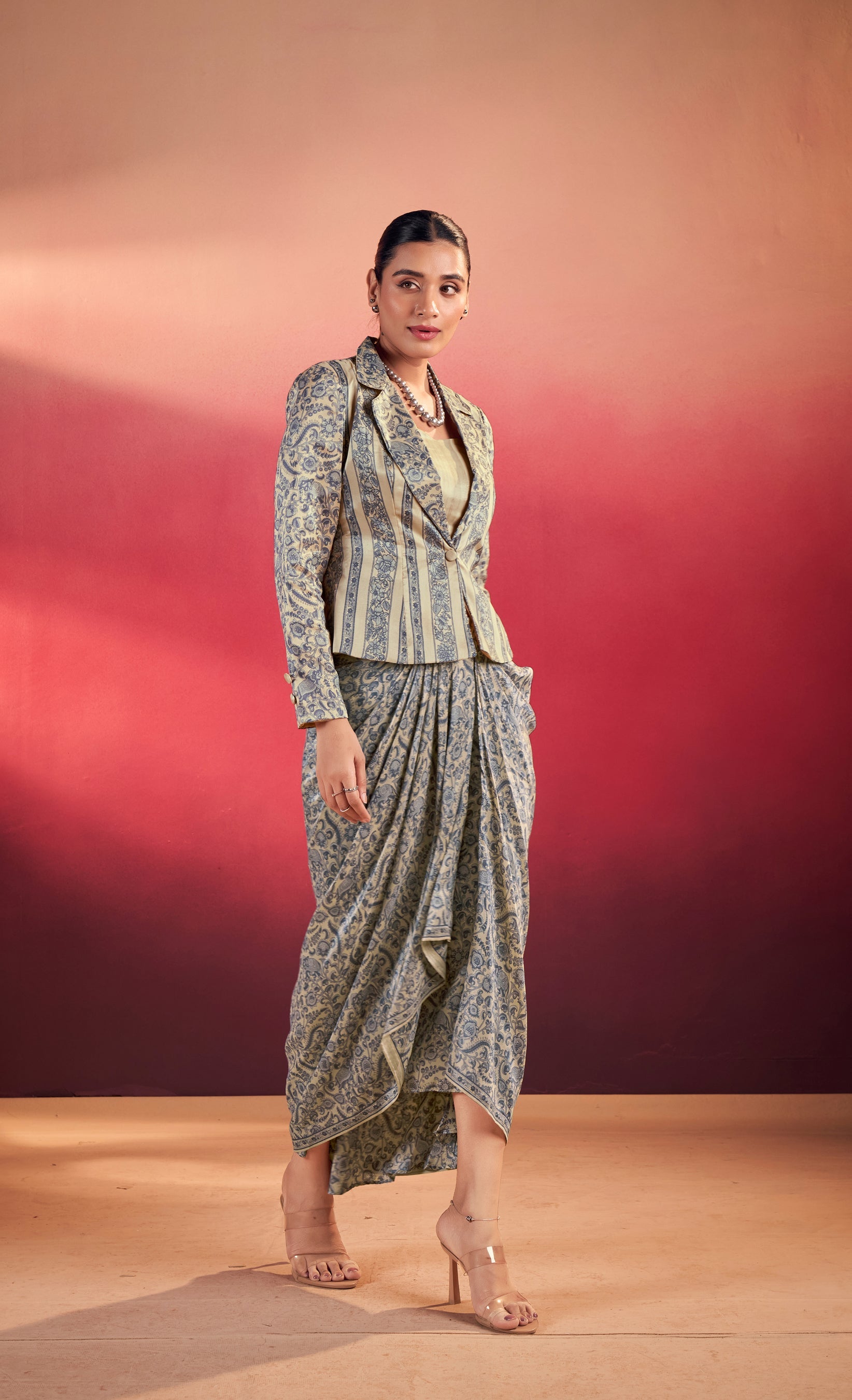 Woman wearing a beige and slate blue floral printed Tasar silk co-ord set with a collared blouse and midi-length skirt.