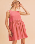 Woman wearing a pink round neck mini tank dress in a casual bohemian style