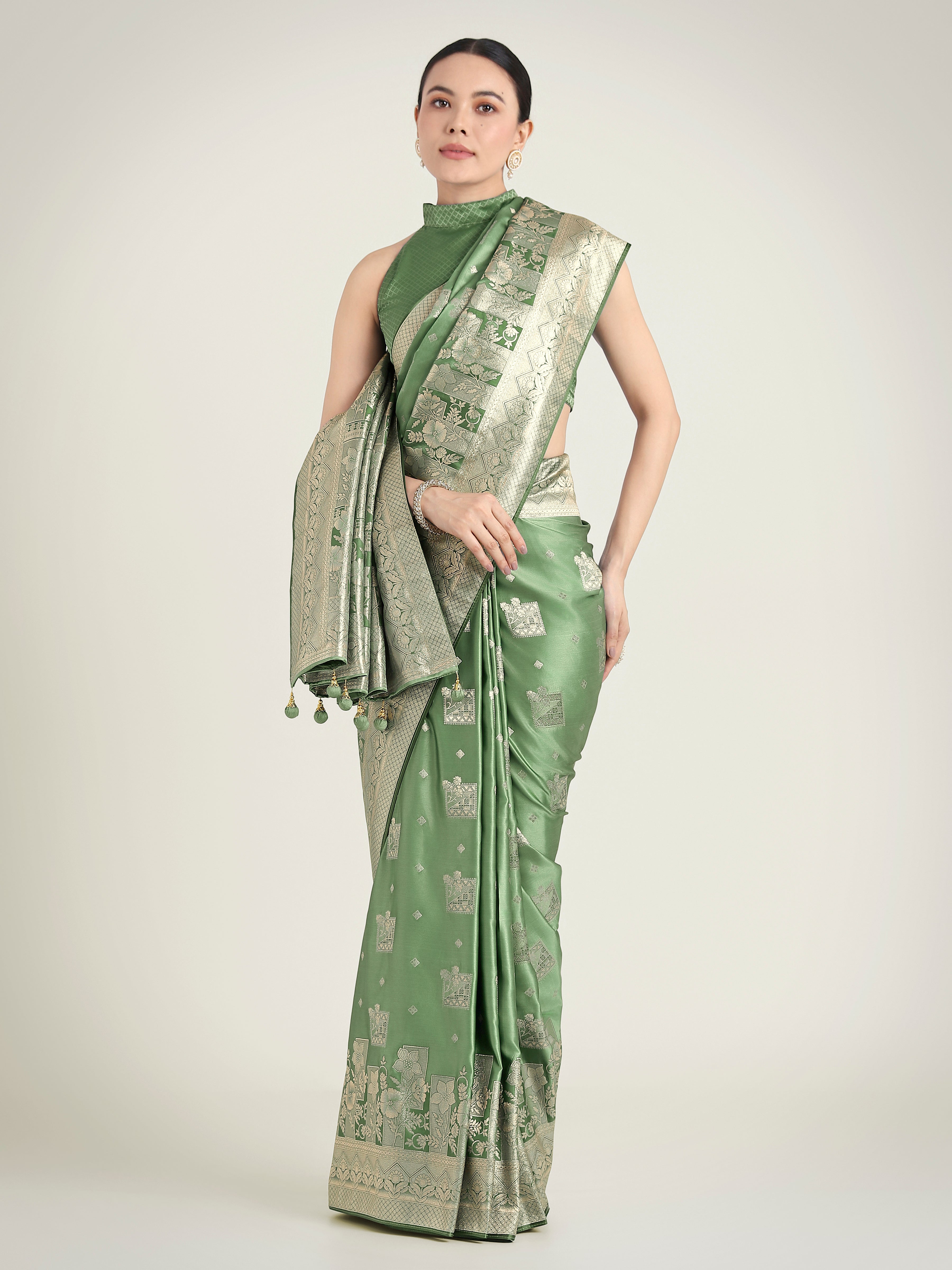 Green Banarasi Satin Silk saree with intricate gold Zari weaving displayed elegantly.