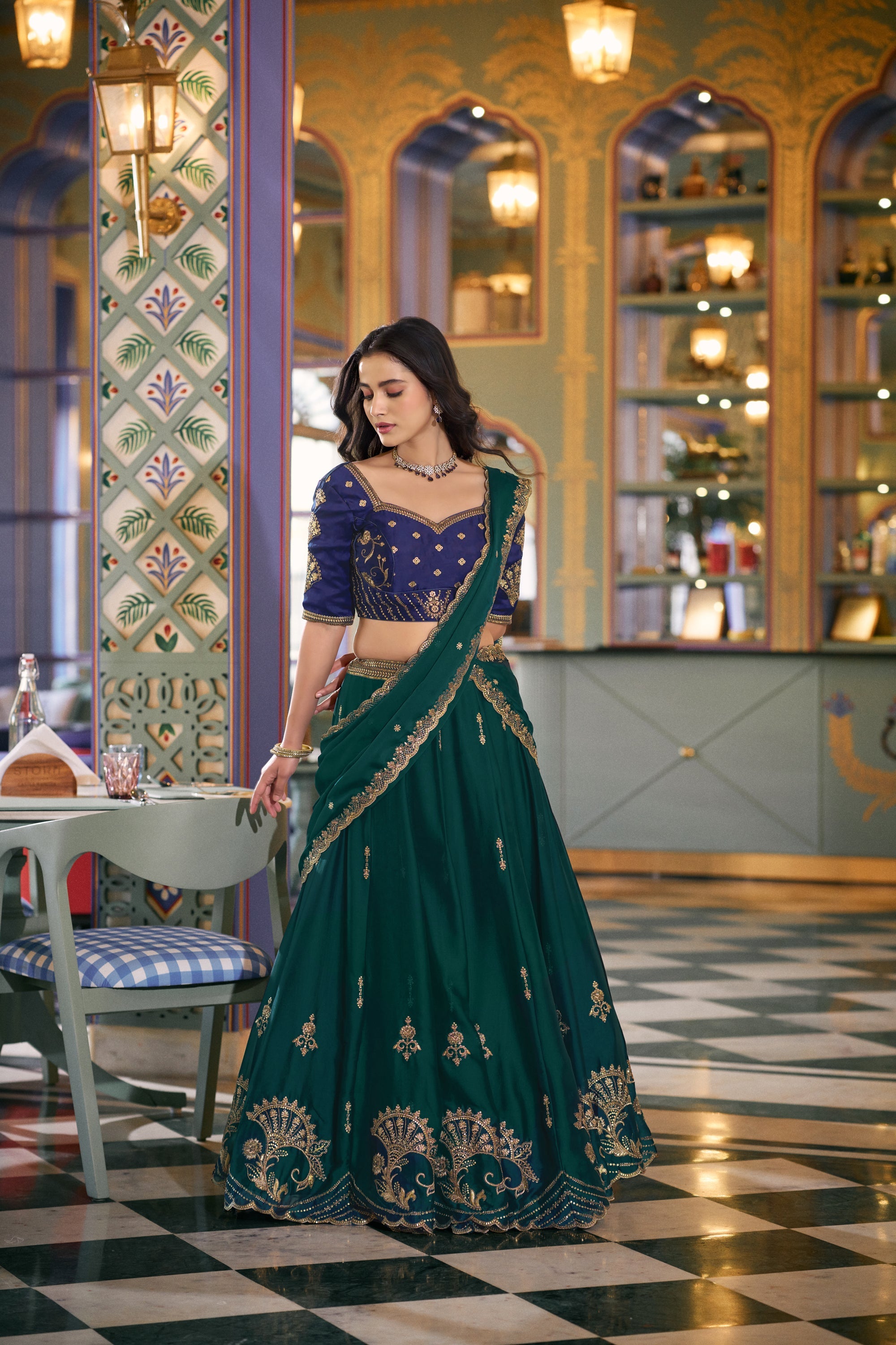 Teal Rangoli silk lehenga choli with heavy sequins and thread embroidery.