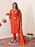 Woman wearing a rust Roman Silk kurta with intricate multi-embroidery and sequins and matching straight-cut pants