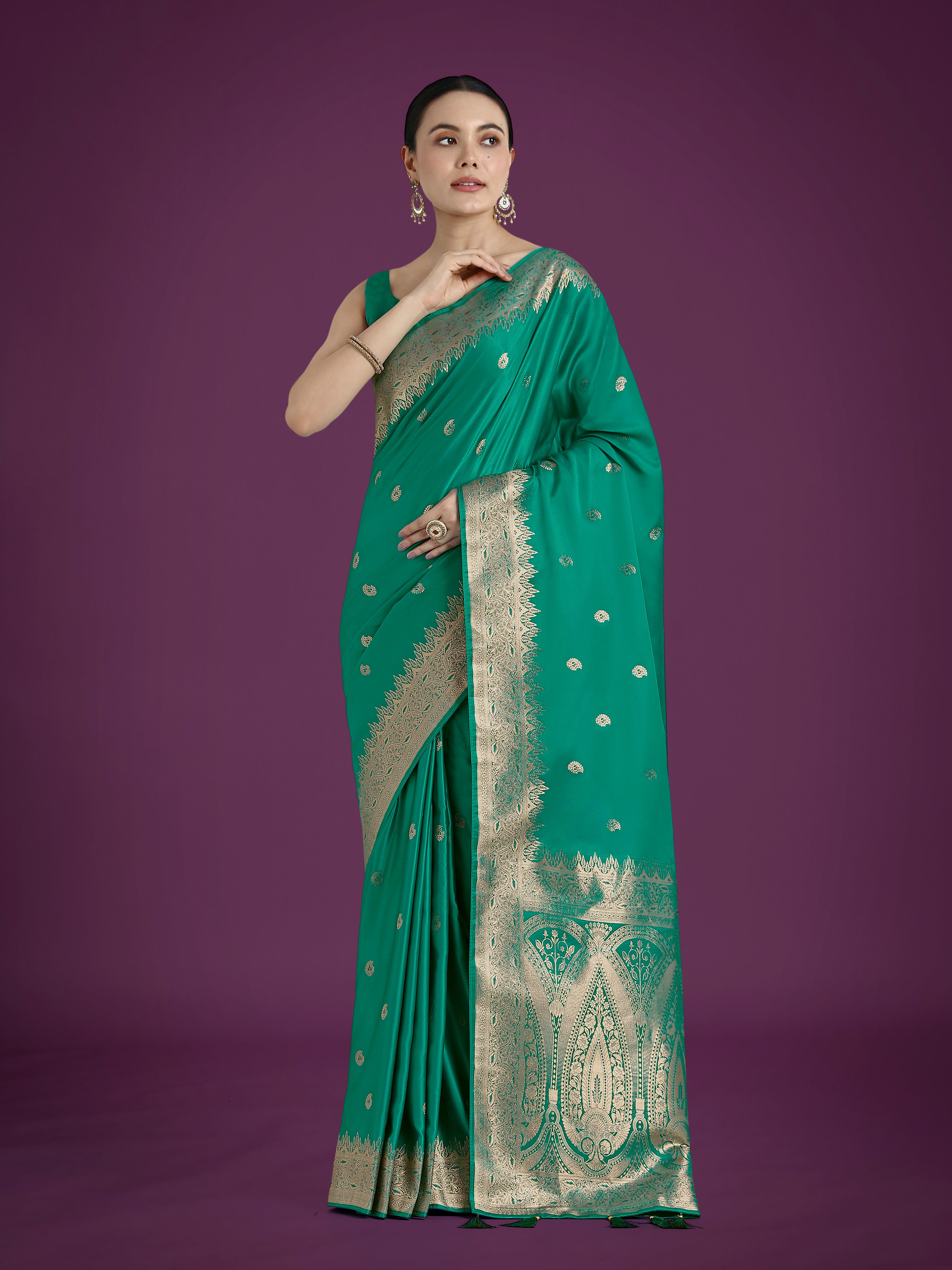 Turquoise soft Banarasi satin silk saree with intricate gold Zari woven borders and matching blouse piece.