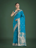 Cyan blue Banarasi satin silk saree with gold Zari weaving detail and matching blouse piece.