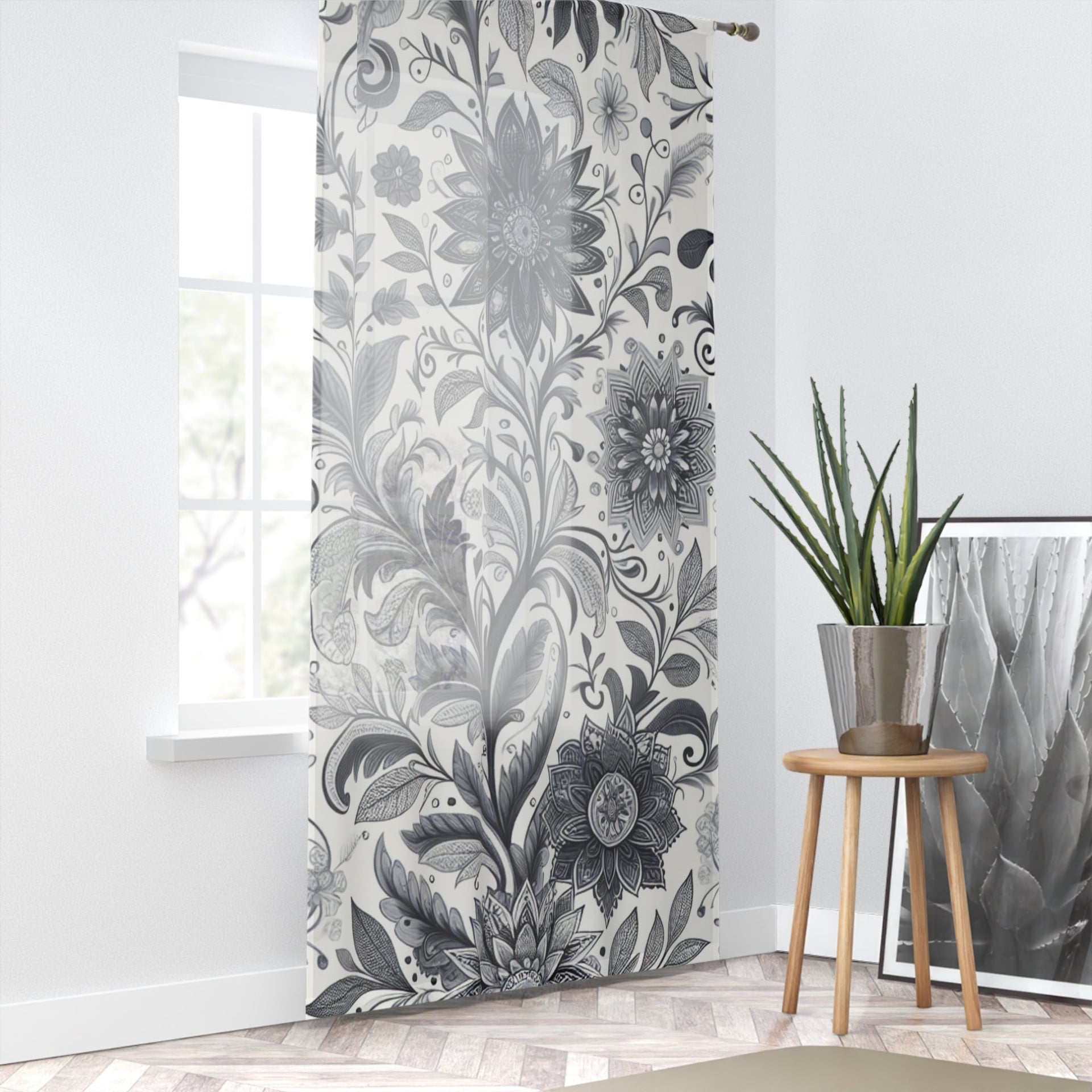 Elegant black and white floral patterned window curtains hanging in a bright modern living room