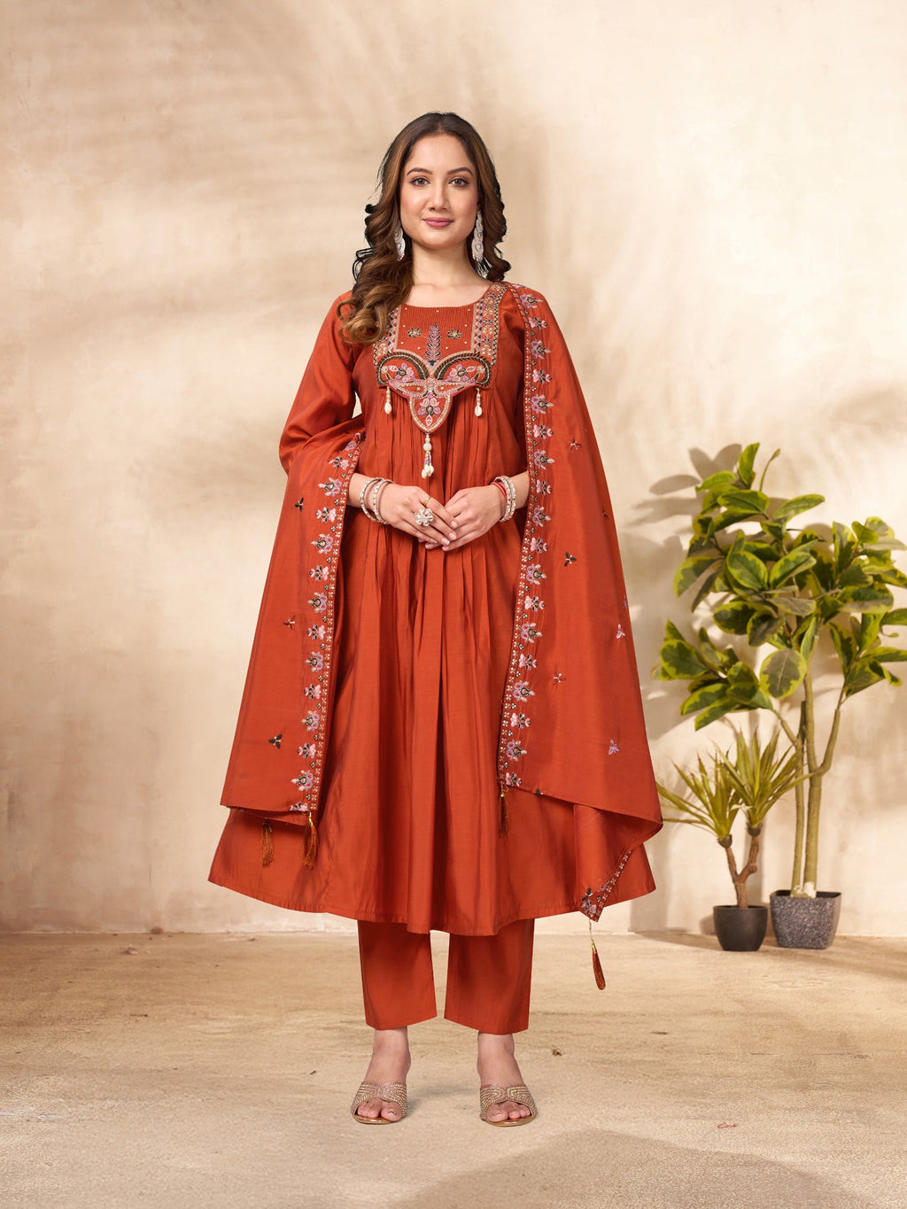 A sophisticated Rust Roman Silk Anarkali Kurti set featuring detailed multi-sequence embroidery and matching dupatta