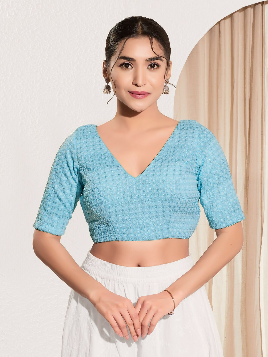 Light blue crochet blouse with V-neck and elbow-length sleeves