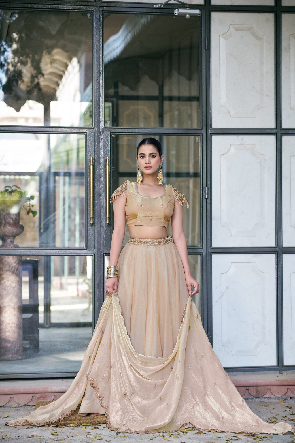 Cream Fendi Silk lehenga choli featuring intricate embroidery and matching belt