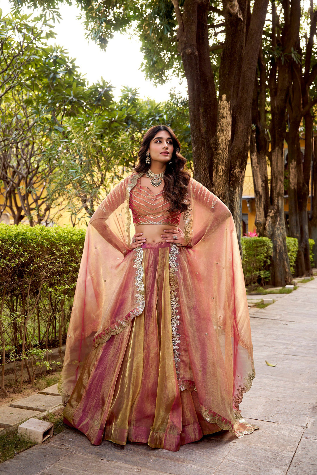 A plain rust-colored Carika silk lehenga choli set with a matching dupatta.